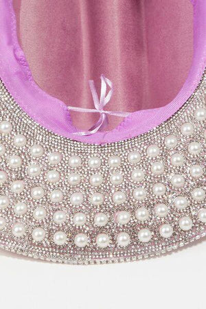 a close up of a purse with pearls on it