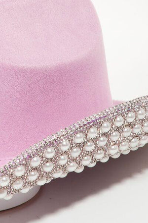a pink hat with pearls on it