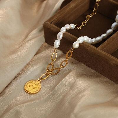 a necklace in a box with a coin on it