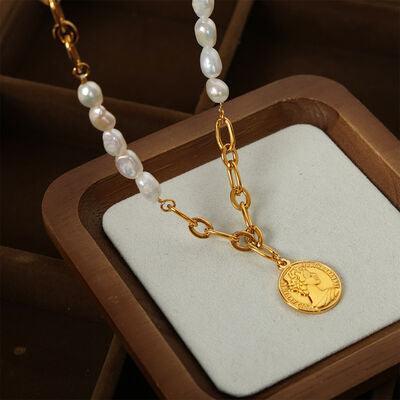 a necklace with a gold coin and pearls