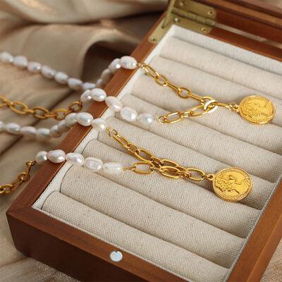 a wooden box containing a necklace and a pair of pearls