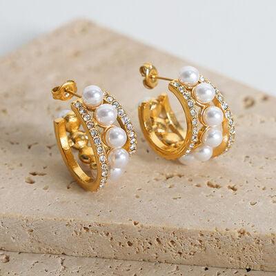 a pair of gold and pearl hoop earrings