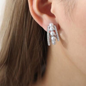 a close up of a person wearing a pair of earrings