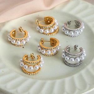 a white plate topped with lots of different types of earrings