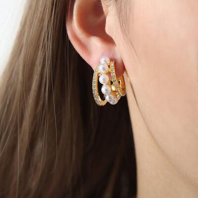 a close up of a person wearing a pair of earrings