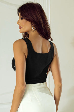 a woman in a black top and white skirt