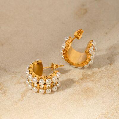 a pair of gold and pearl earrings