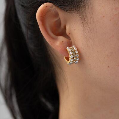 a close up of a person wearing a pair of earrings