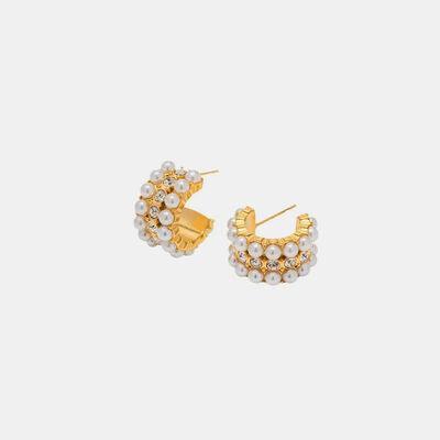 a pair of gold and pearl earrings