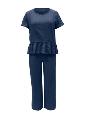 a woman wearing a blue top and pants
