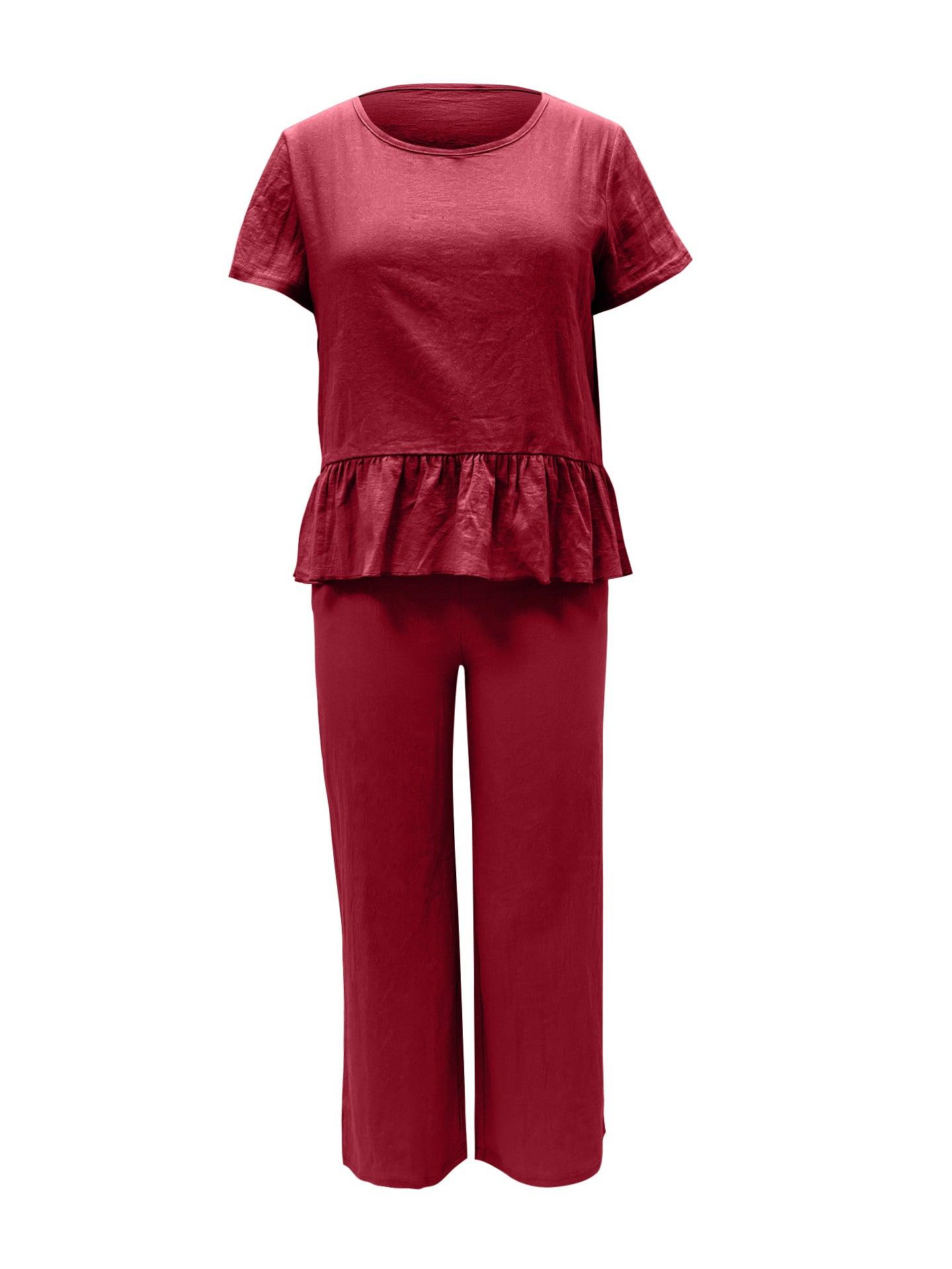 a woman wearing a red top and pants