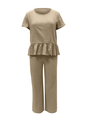 a woman wearing a tan top and pants