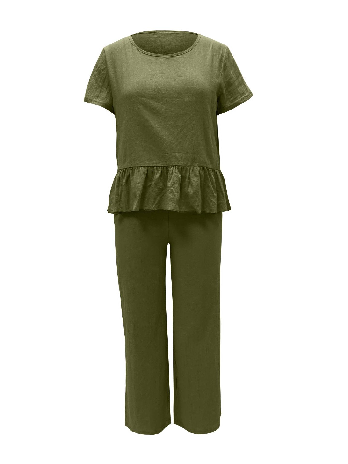 a woman wearing a green top and pants