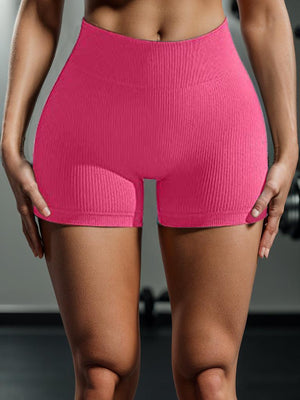 a woman in a pink shorts with her hands on her hips