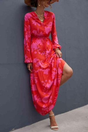 a woman leaning against a wall wearing a red dress