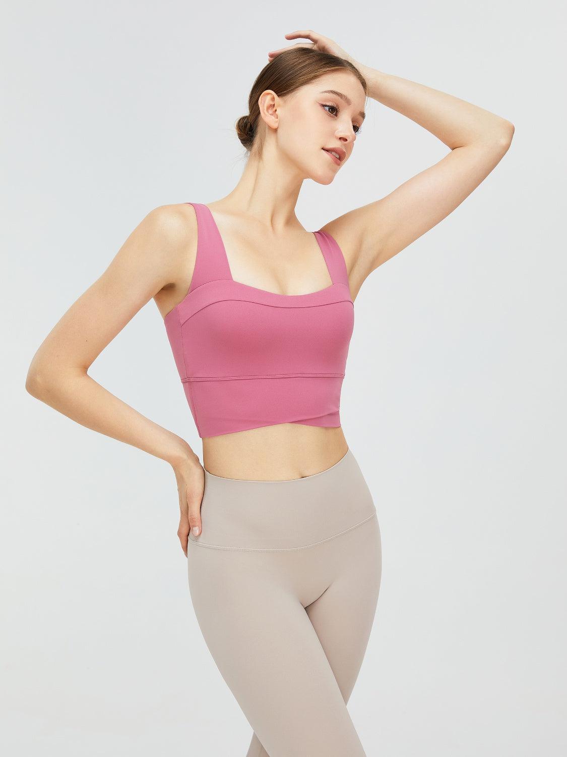 a woman in a pink sports bra top and leggings