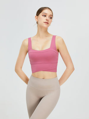 a woman in a pink top and grey leggings