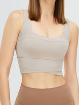 a woman wearing a tan sports bra top
