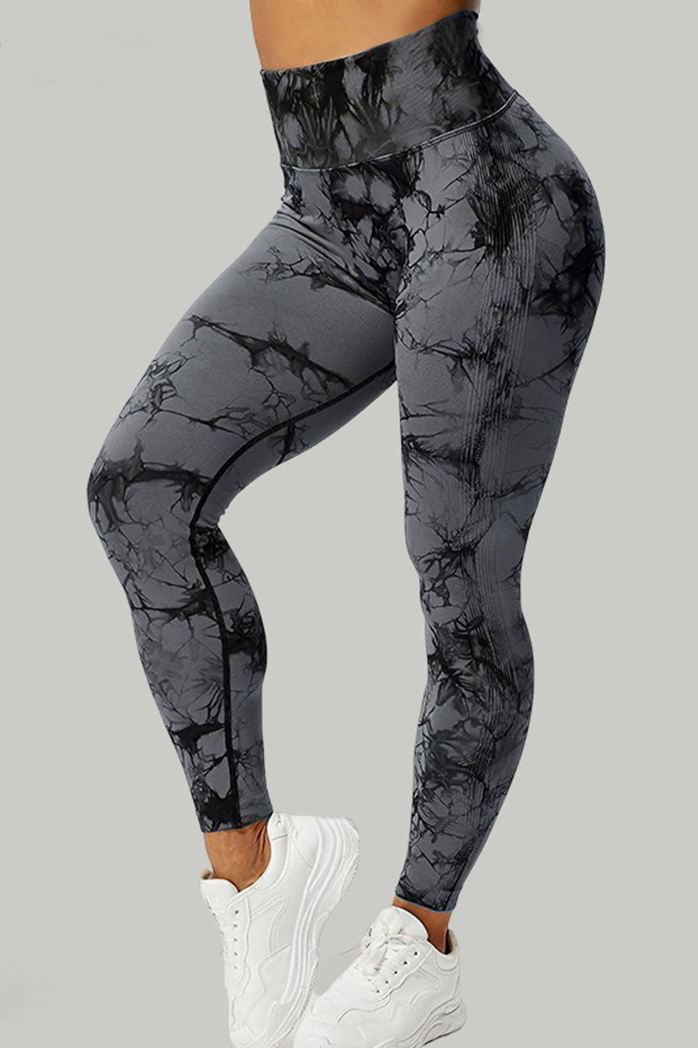 a woman in black and white marble print leggings
