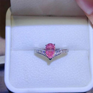 a pink diamond ring in a white box