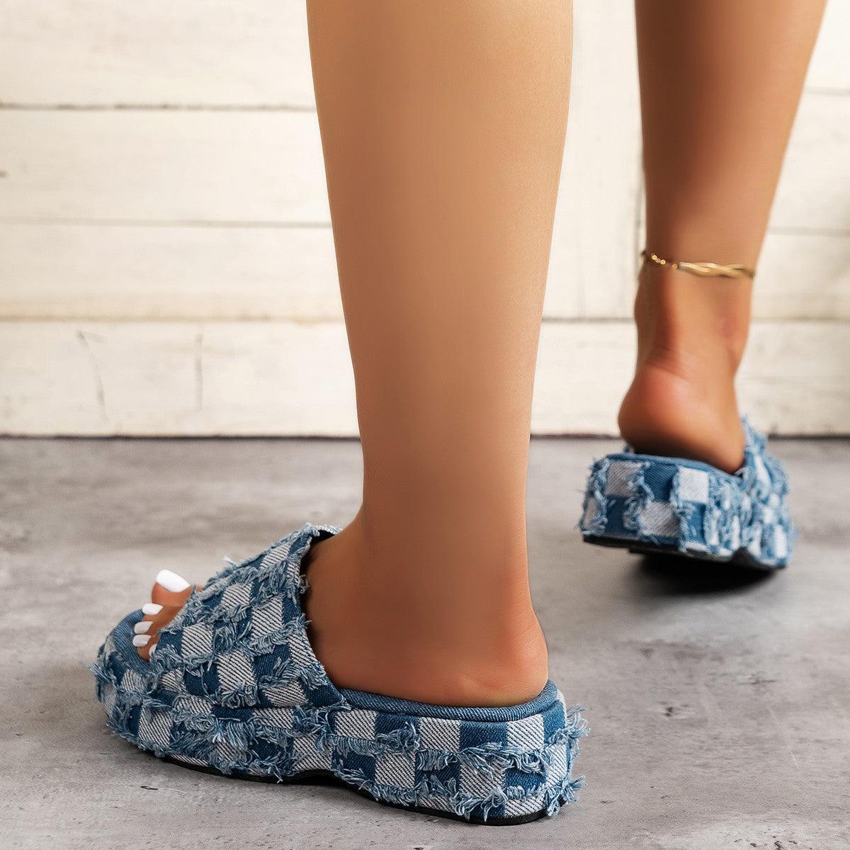 a close up of a person's feet wearing blue slippers