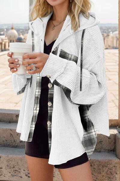 a woman holding a cup of coffee while standing on steps