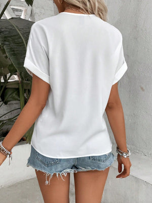 a woman wearing a white shirt and denim shorts