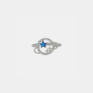 a white gold ring with a blue star in the middle