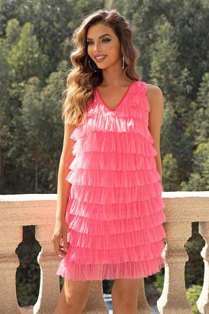 a woman in a pink dress posing for a picture