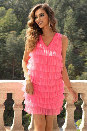 a woman in a pink dress posing for a picture