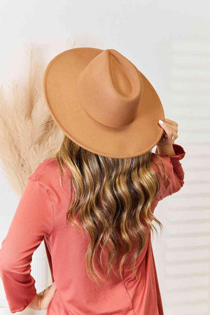 a woman wearing a brown hat with long hair