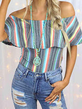 a woman wearing a striped top and ripped jeans