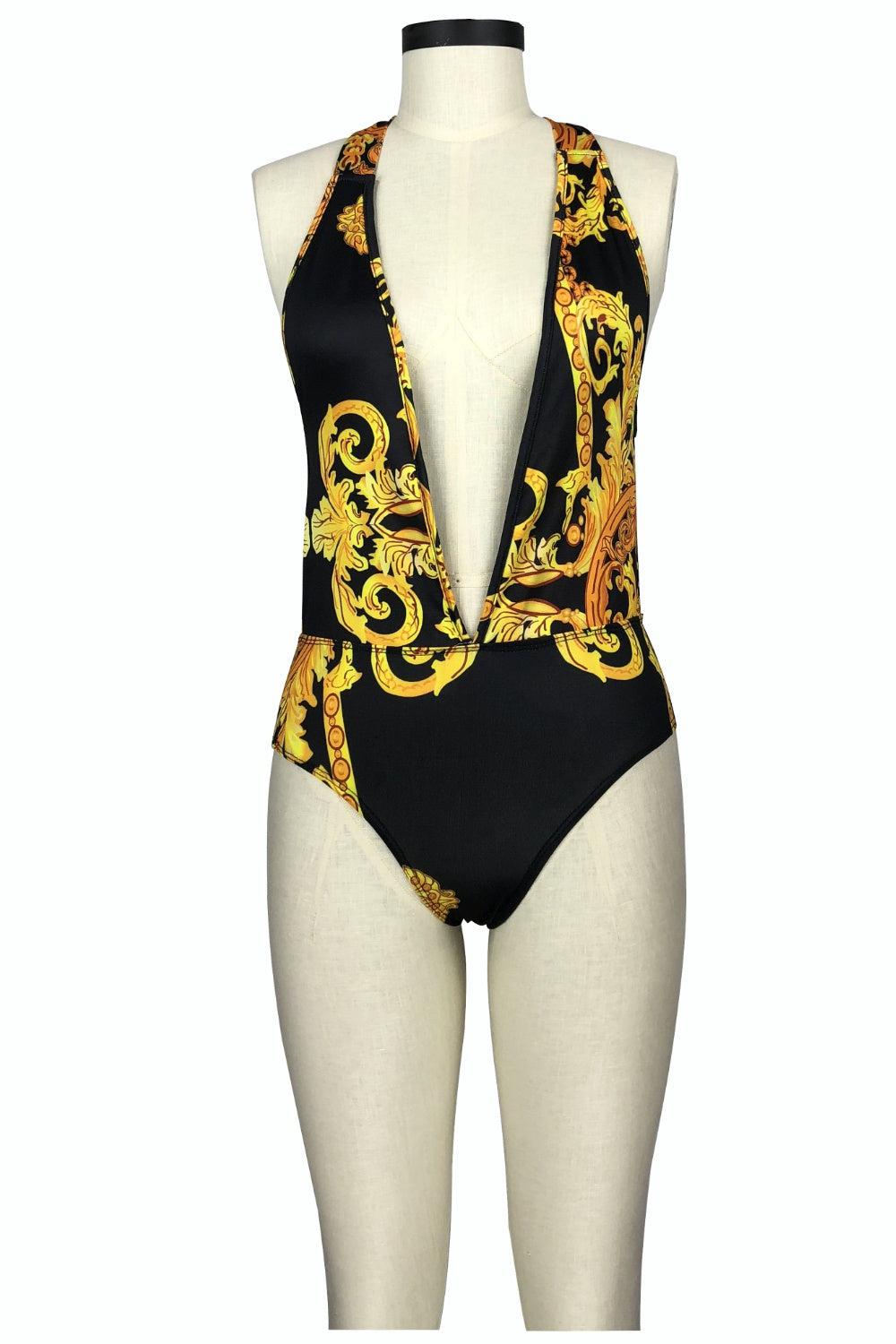 a female mannequin wearing a black and gold swimsuit