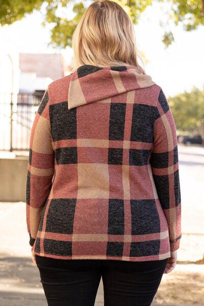 a woman walking down a sidewalk wearing a plaid jacket