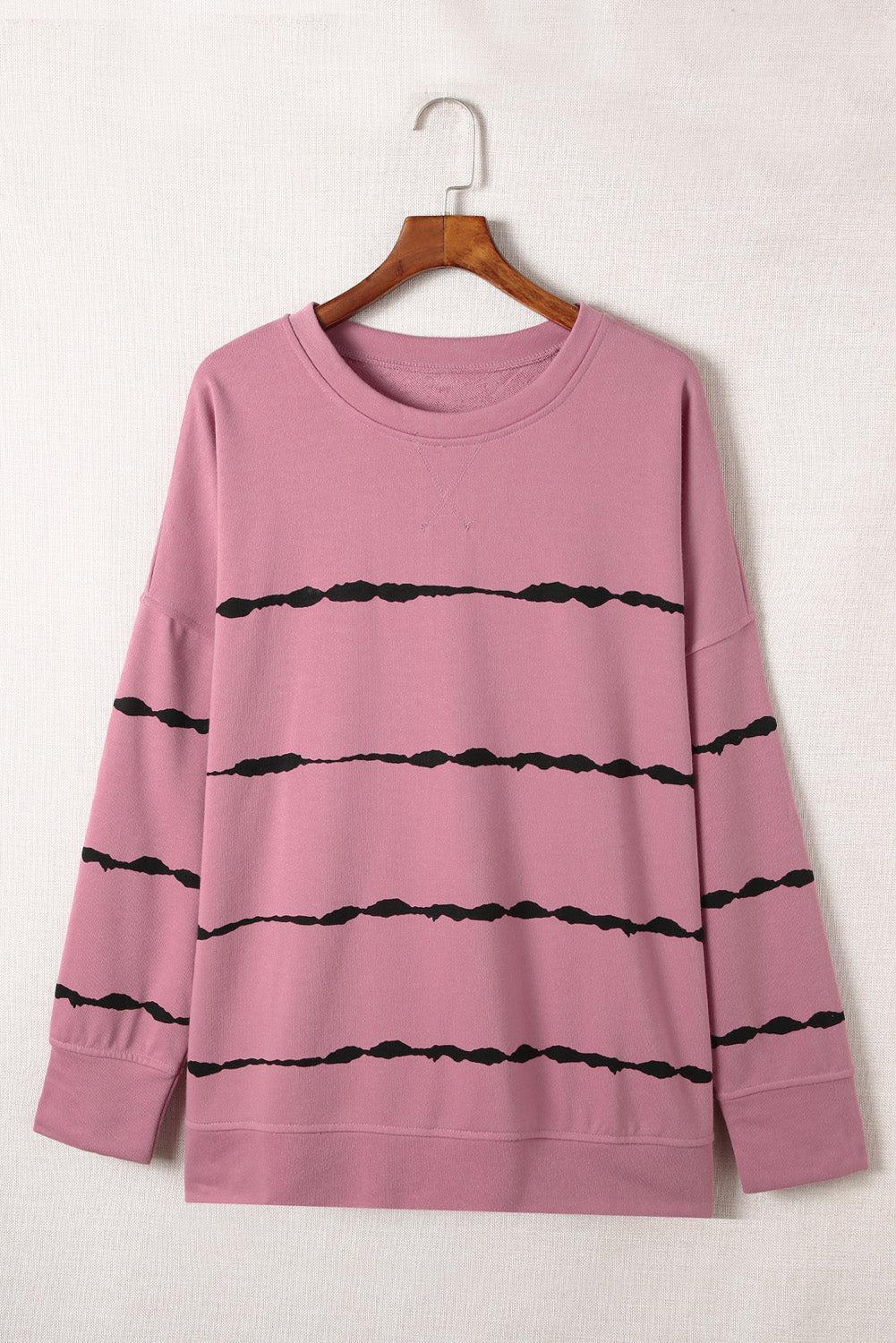 a pink shirt with black lines on it