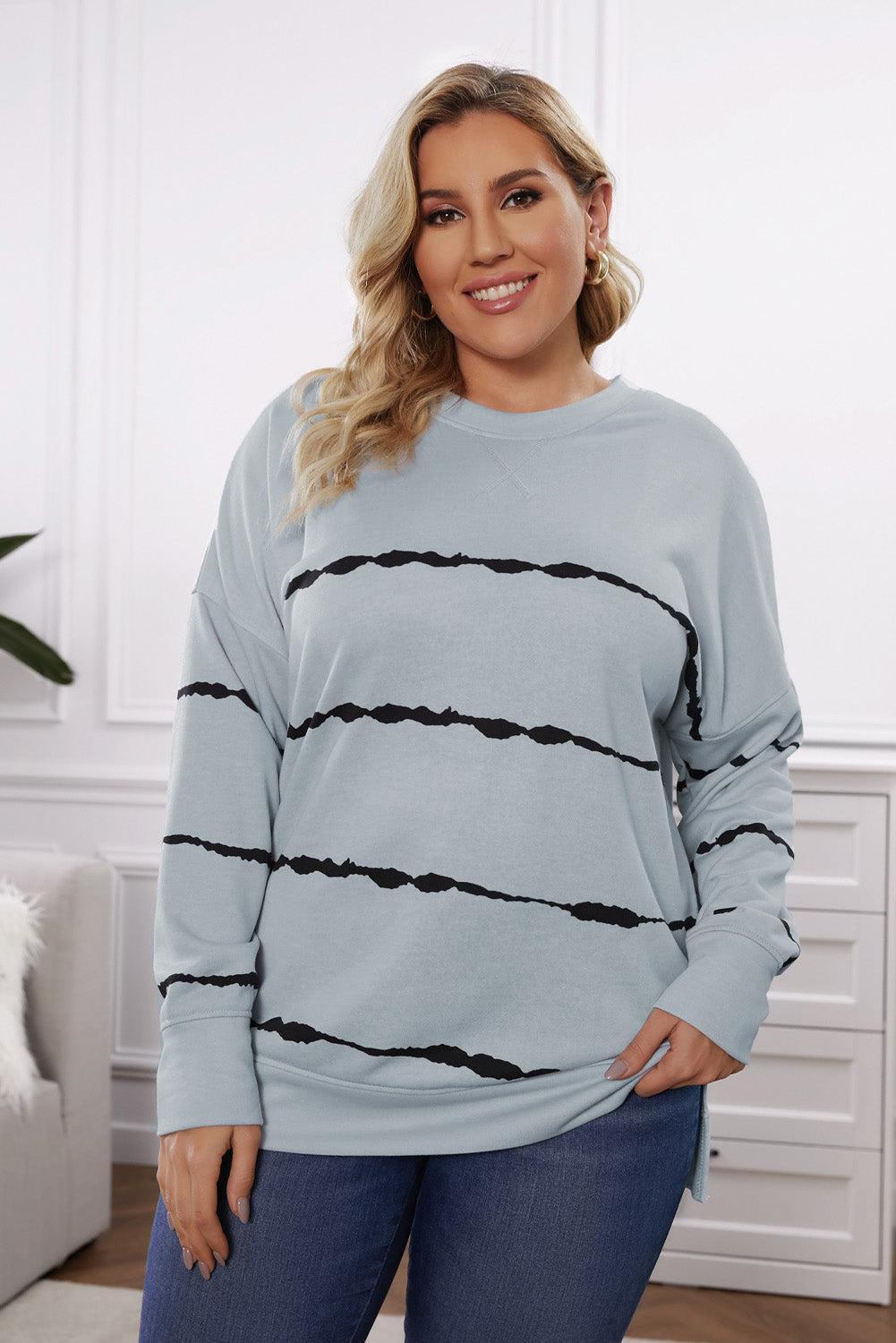 a woman wearing a blue sweater with black stripes
