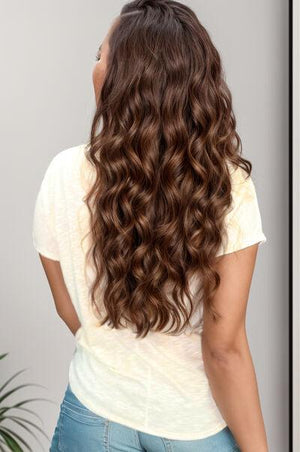 the back of a woman's head with long curly hair