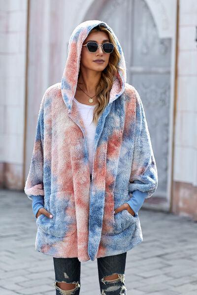 a woman wearing a blue and pink tie dye coat