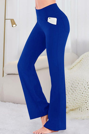 a woman in blue pants is posing for a picture