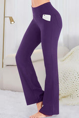 a woman in purple pants standing on a bed