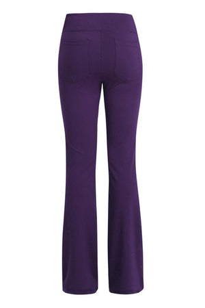 a woman wearing purple pants and heels