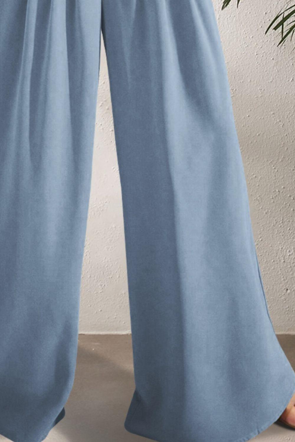 a woman wearing a pair of blue pants