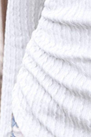 a close up of a person wearing a white sweater