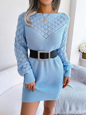 a woman in a blue sweater dress posing for a picture