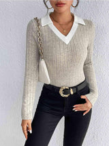 a woman wearing a white sweater and black pants