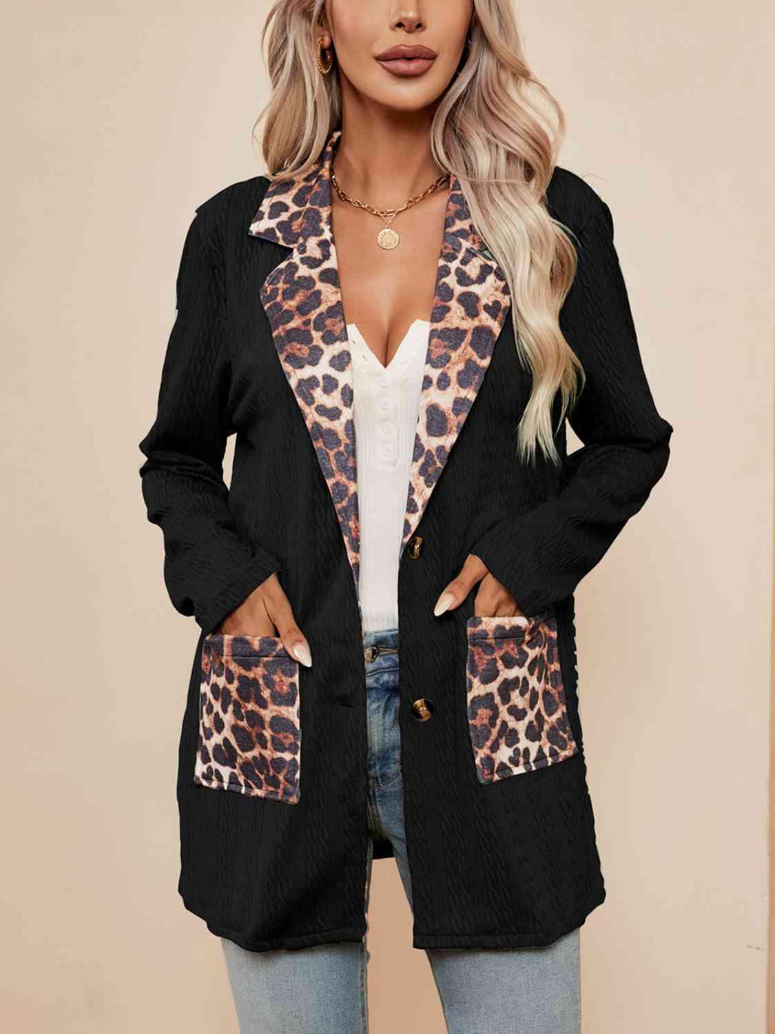 a woman wearing a black jacket with a leopard print pocket
