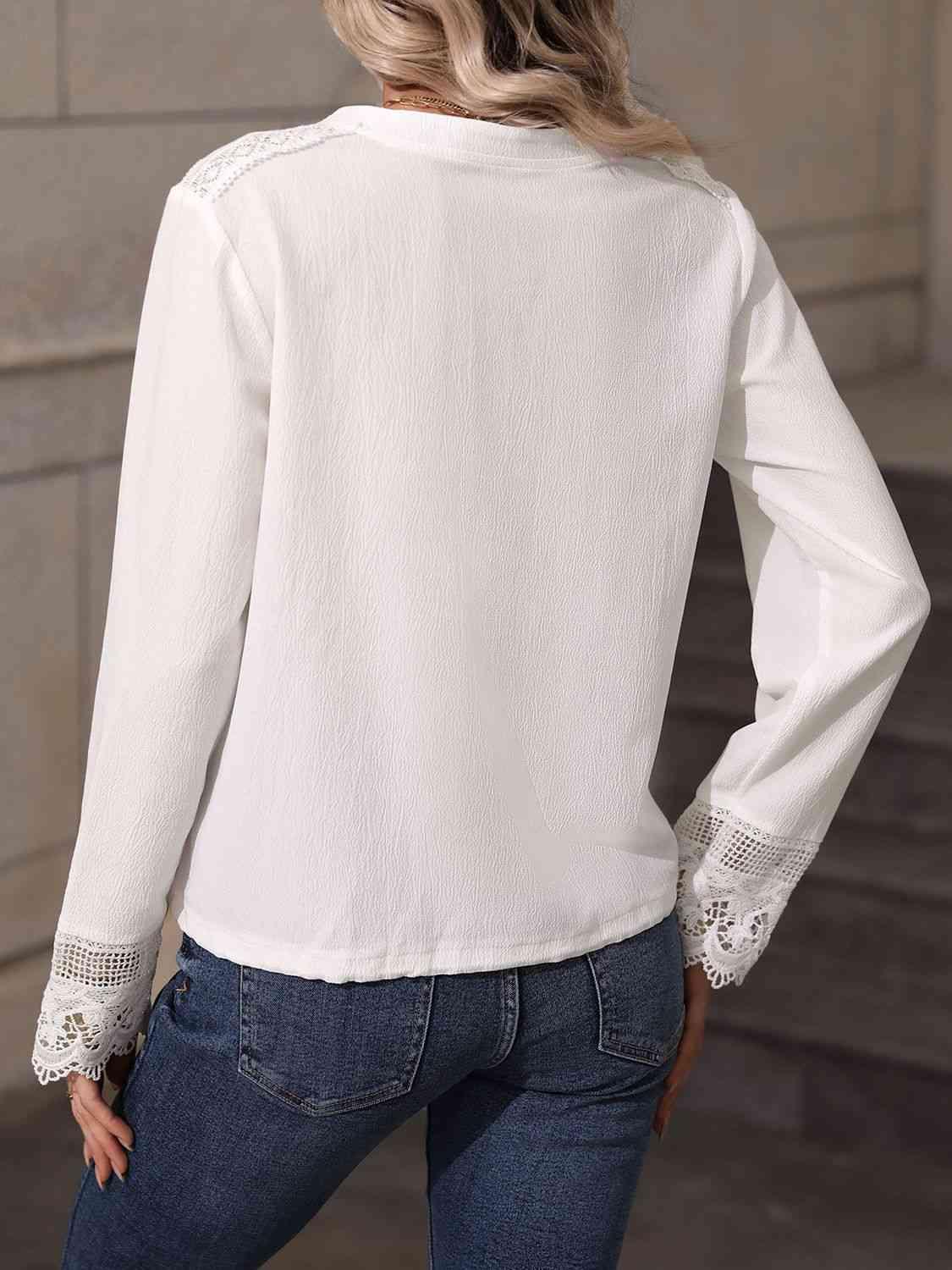 a woman wearing a white blouse and jeans