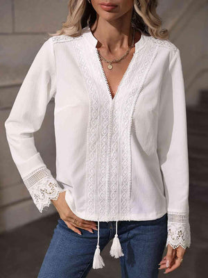 a woman wearing a white blouse and jeans