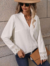 a woman wearing a white blouse and jeans