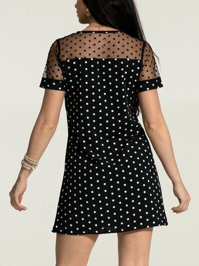 a woman in a black and white polka dot dress